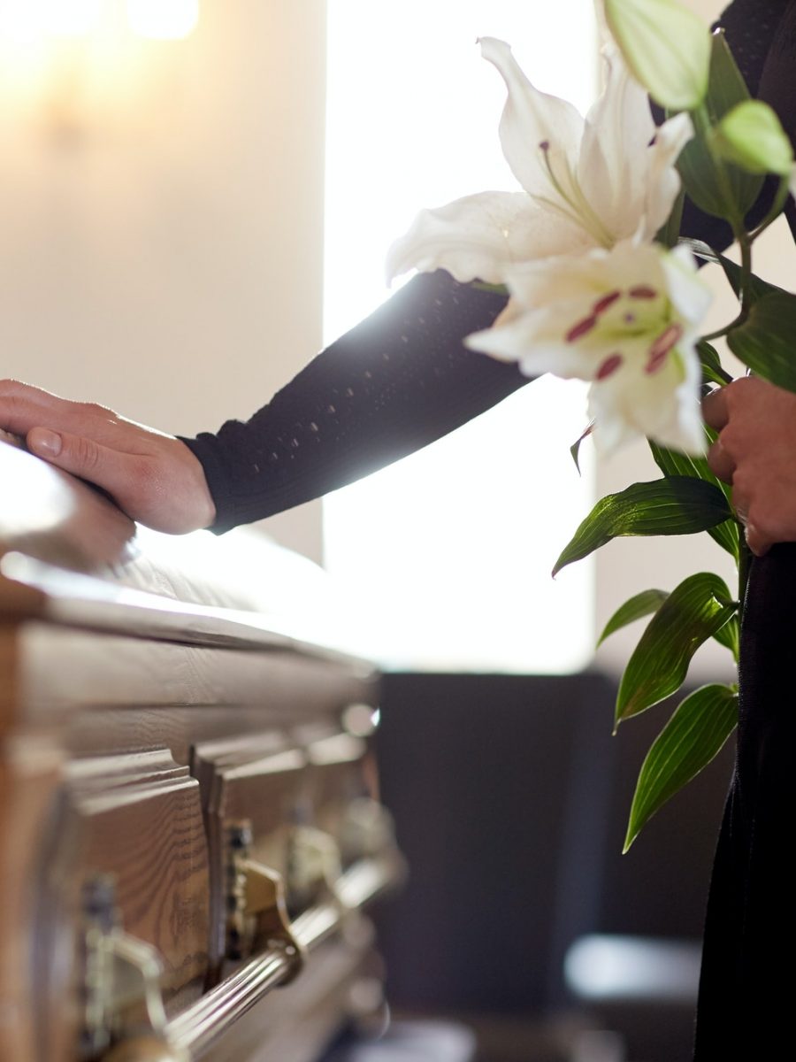 woman-with-lily-flowers-and-coffin-at-funeral.jpg woman-with-lily-flowers-and-coffin-at-funeral.jpg